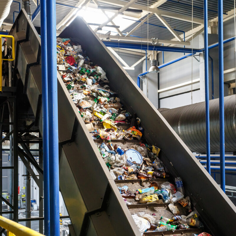 moving conveyor transporter on Modern waste recycling processing plant. Separate and sorting garbage collection. Recycling and storage of waste for further disposal.